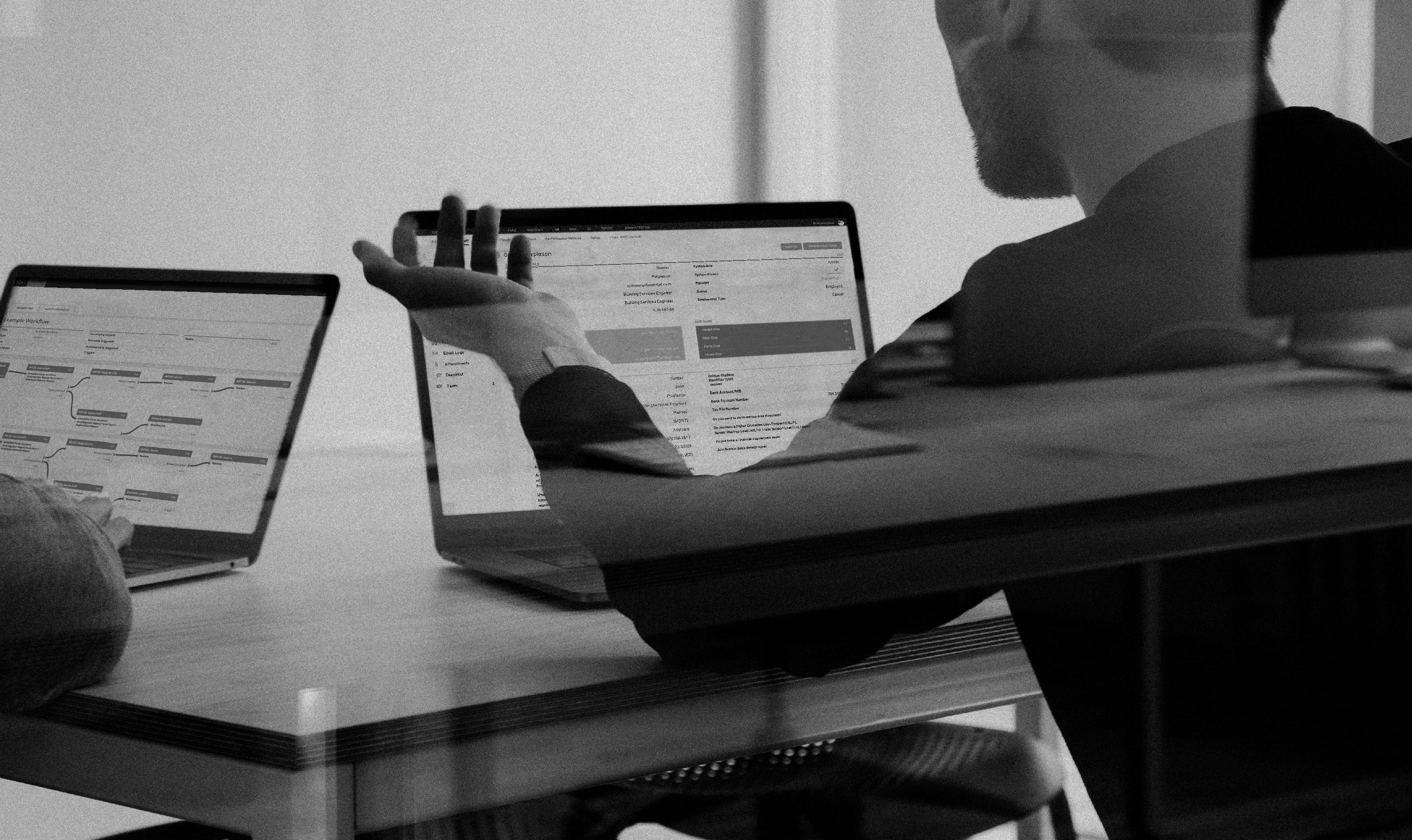 People working in the office with there laptops opened on different pages of the software