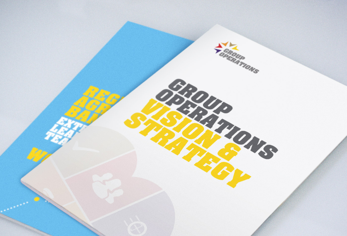 two booklets for Commbank lay on a white table