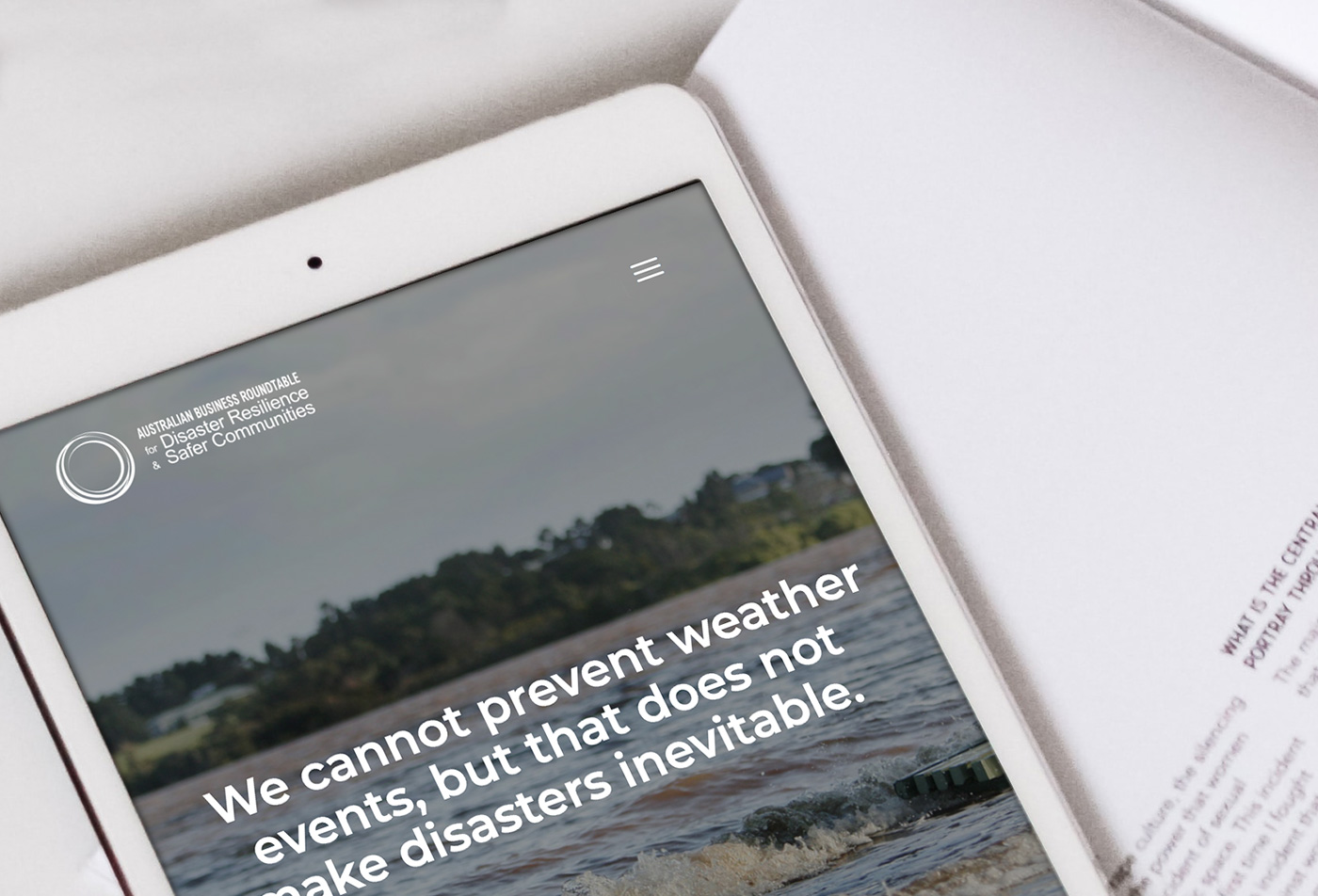 An iPad laying on a table with The Australian Business Roundtable home page opened.