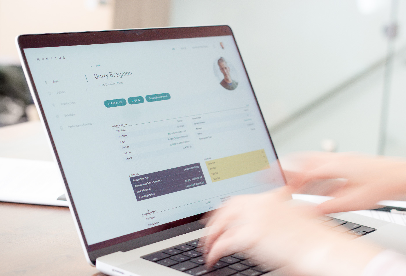 Someone is working on a laptop where workforce management
                    and payroll software is opened